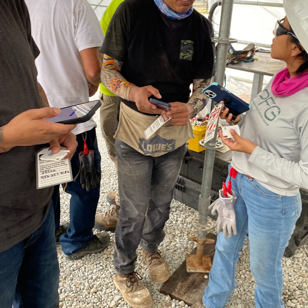 workers standing on jobsite with lockout ids